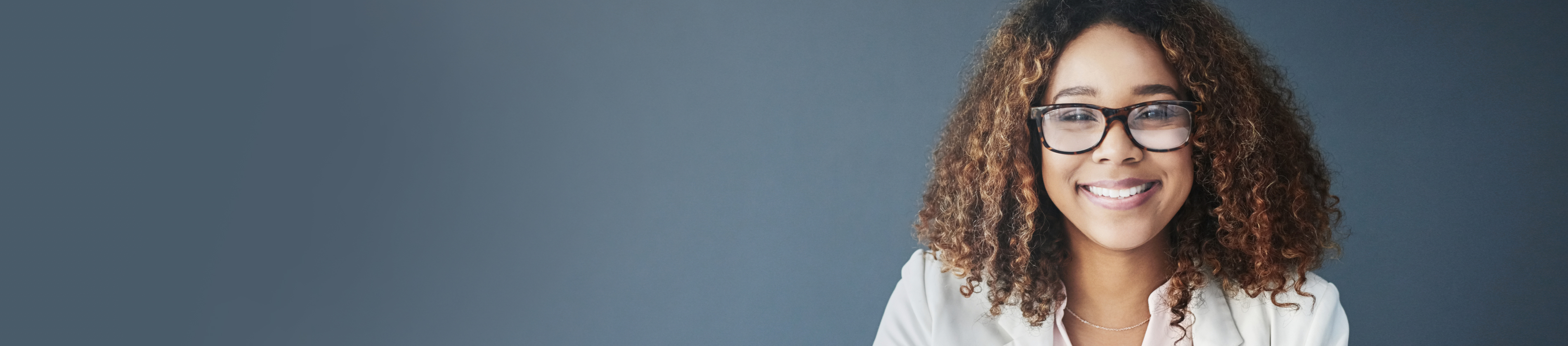 Smiling professional woman wearing glasses.